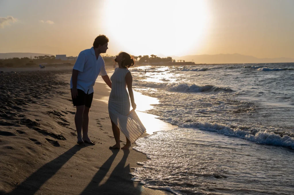 Engaged couple embracing by the sea in Crete