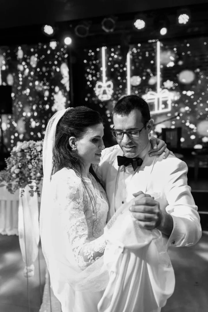 Black and white photo of bride and groom dancing during their wedding reception in Chania, Crete