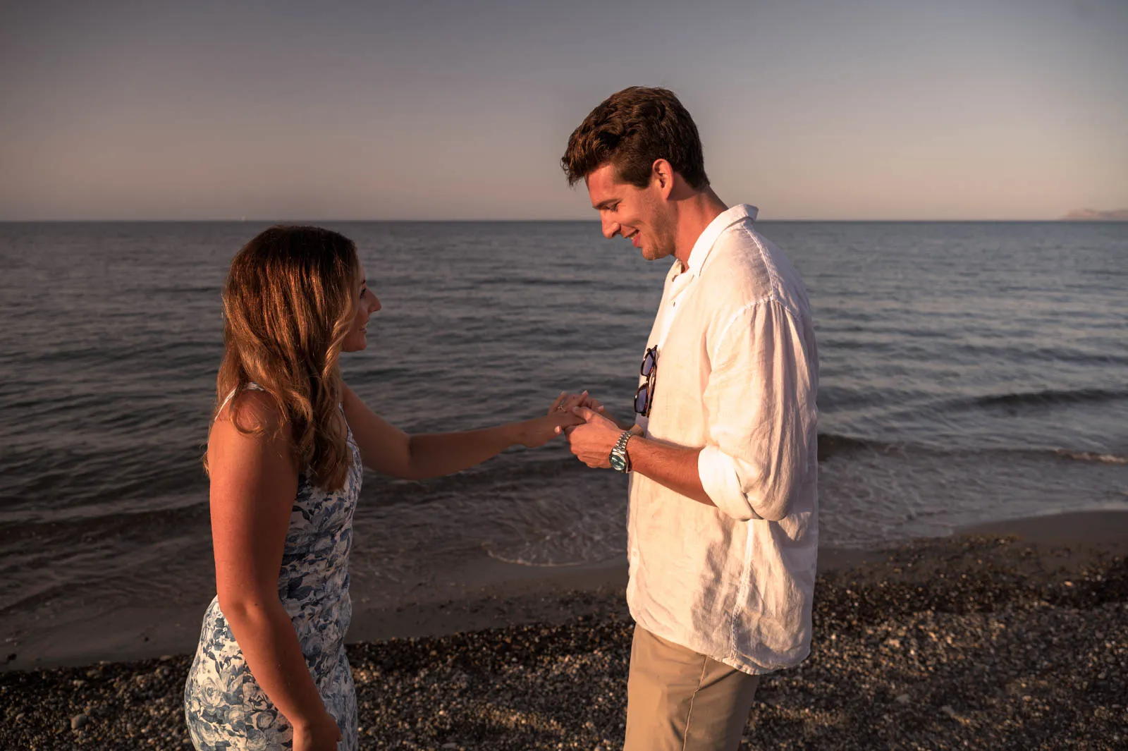Marriage proposal moment at Maleme Beach in Crete during golden hour