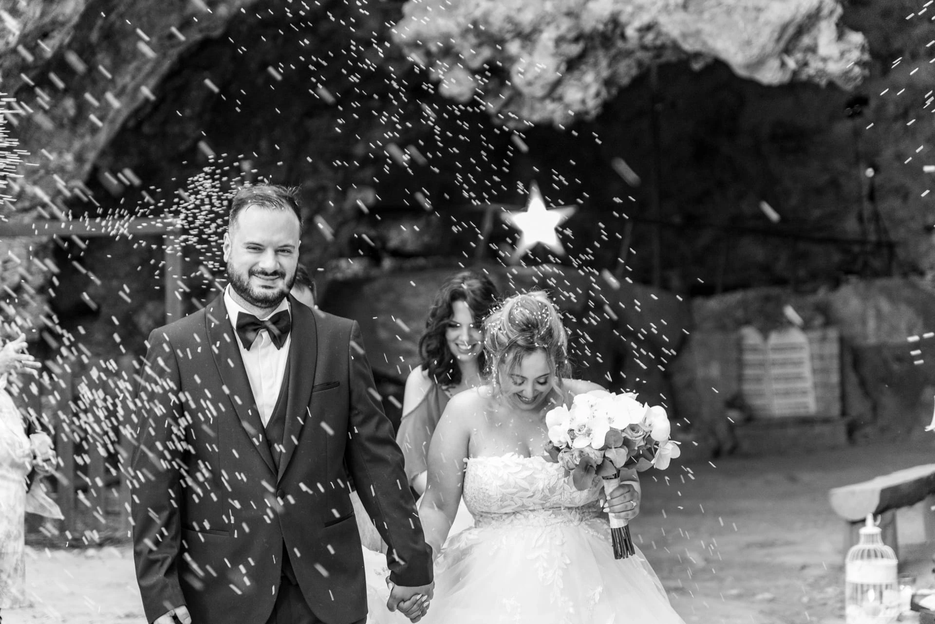 Bride and groom outside Saint John the Hermit Cave after their Orthodox wedding ceremony in Marathokefala, Crete.